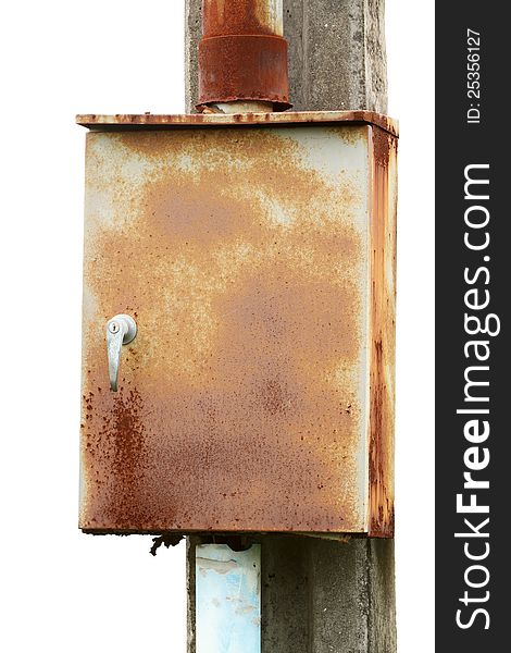 Rusty electric control box on concrete pole isolated on white background