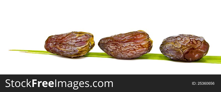 Ripe dates and leaf isolated on white background. Ripe dates and leaf isolated on white background