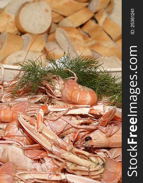 Crayfish and dill on a plate, bread int the background. Crayfish and dill on a plate, bread int the background