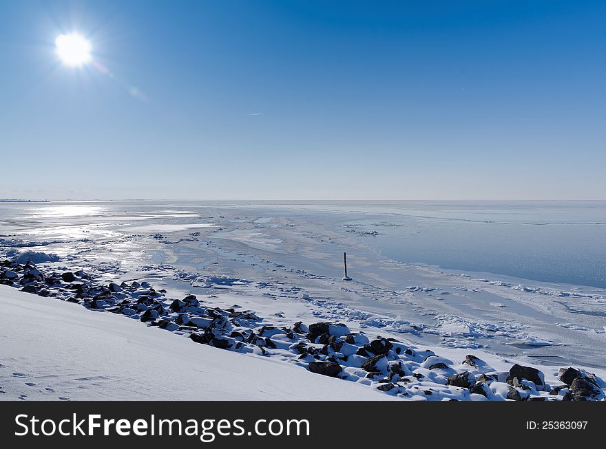 Sunny view across frozen lake