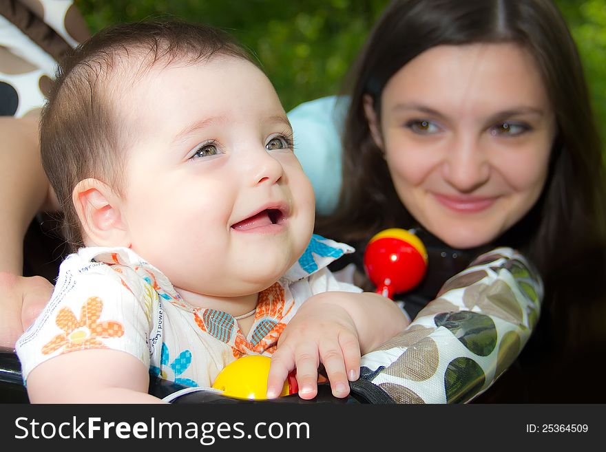 Smiling kid on the background of his mother. Smiling kid on the background of his mother