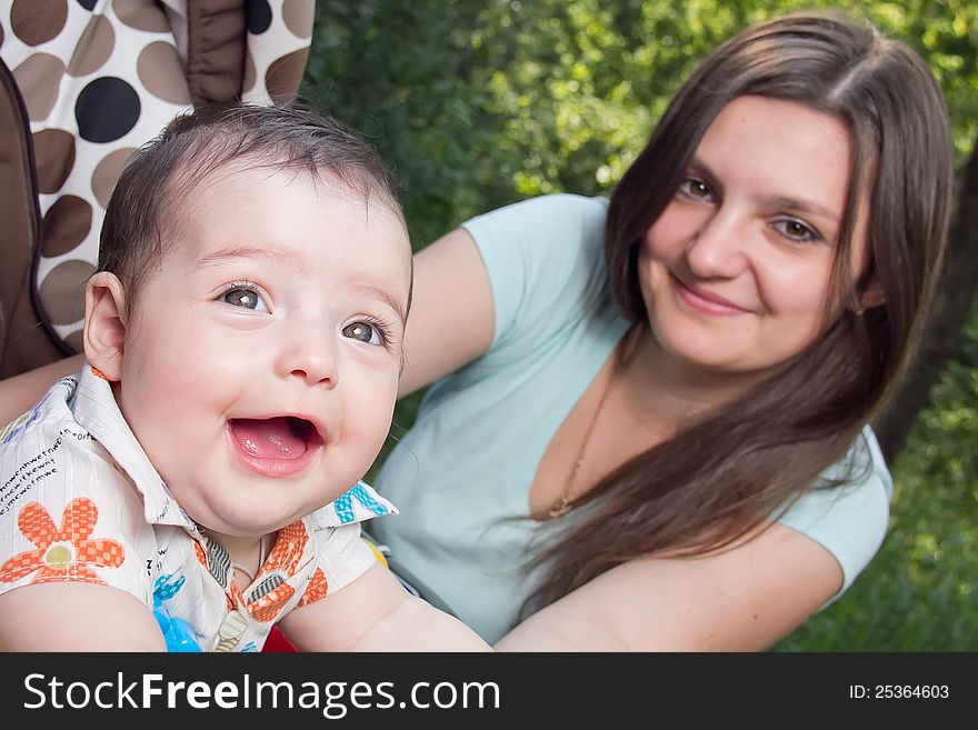 Smiling kid on the background of his mother. Smiling kid on the background of his mother