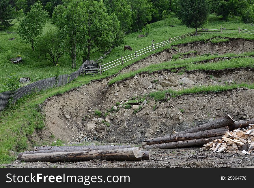 Cut branches at a wood exploitation and stored on a mountain valley