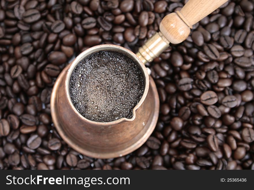 Arab coffee pot over coffee beans background. Arab coffee pot over coffee beans background