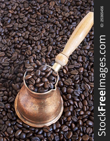 Arab coffee pot over coffee beans background. Arab coffee pot over coffee beans background