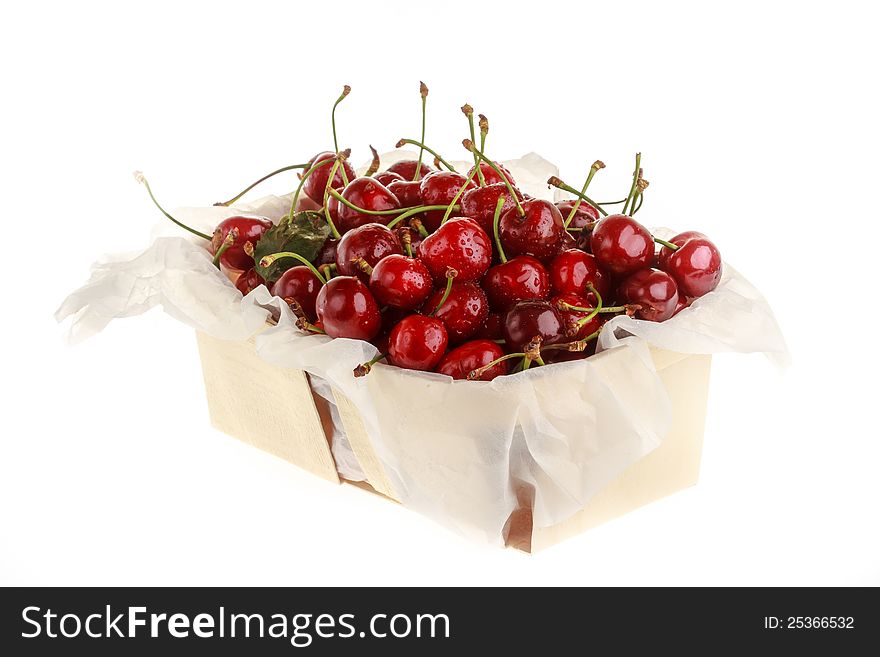 Fresh red cherry in wooden basket