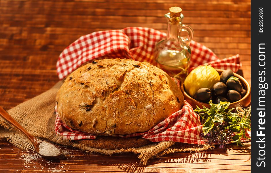 Loaf of traditionally baked rustic bread with provence herbs