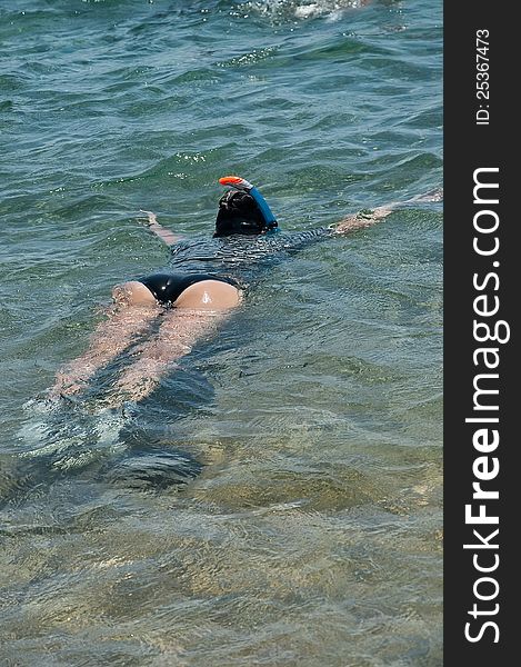 The driver floating on a sea surface with a mask and snorkel. The driver floating on a sea surface with a mask and snorkel