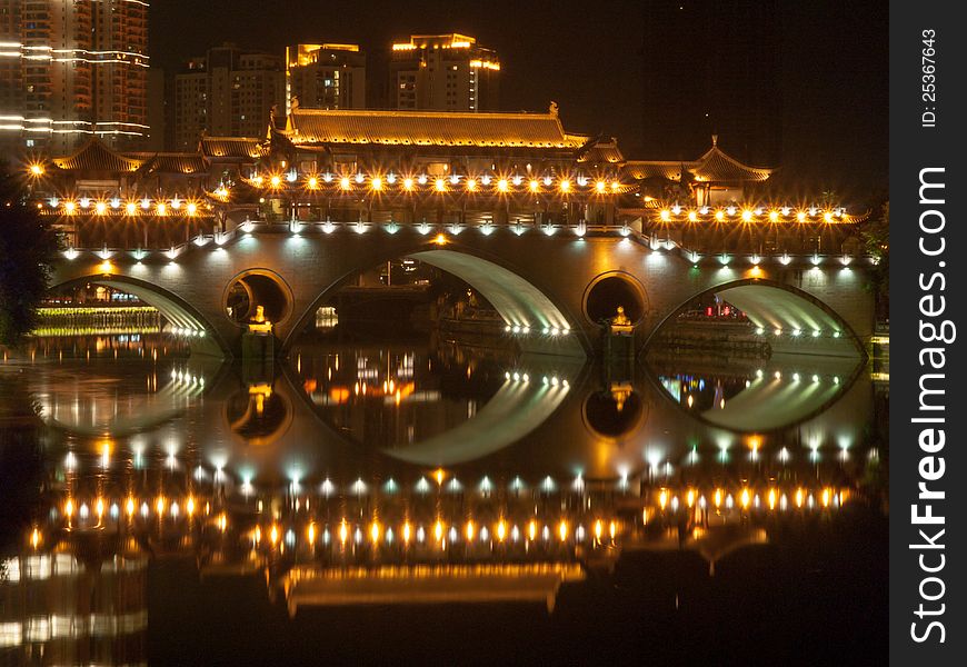 A chinese arch bridge ablaze with lights. A chinese arch bridge ablaze with lights