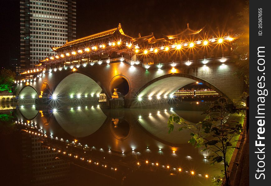 A chinese arch bridge ablaze with lights. A chinese arch bridge ablaze with lights