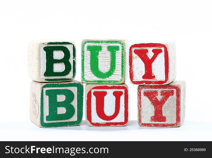 Wooden childrens blocks spelling 'buy'