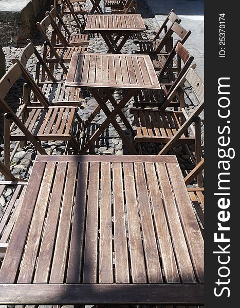 Group of wood tables outdoor restaurant ready to be served, Aviles, Asturias, Spain