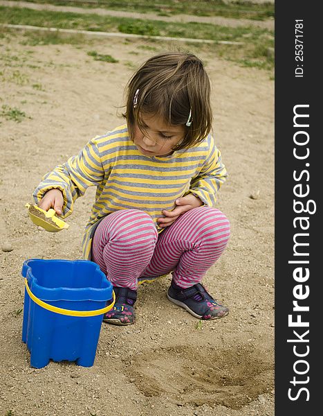 Child Playing In The Sand