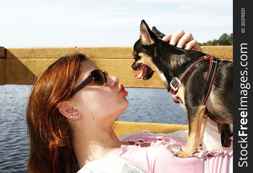 Teenage girl kissing her Chihuahua. Teenage girl kissing her Chihuahua