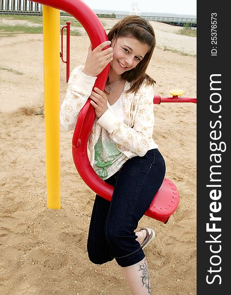 Teenage Girl having fun on an item in the playground. Teenage Girl having fun on an item in the playground