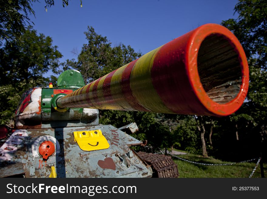 Old army tank painted by children in the garden. Old army tank painted by children in the garden