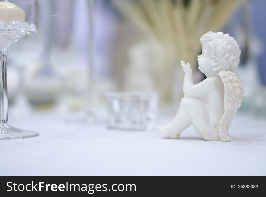 Romantic table set with angel, blurry background