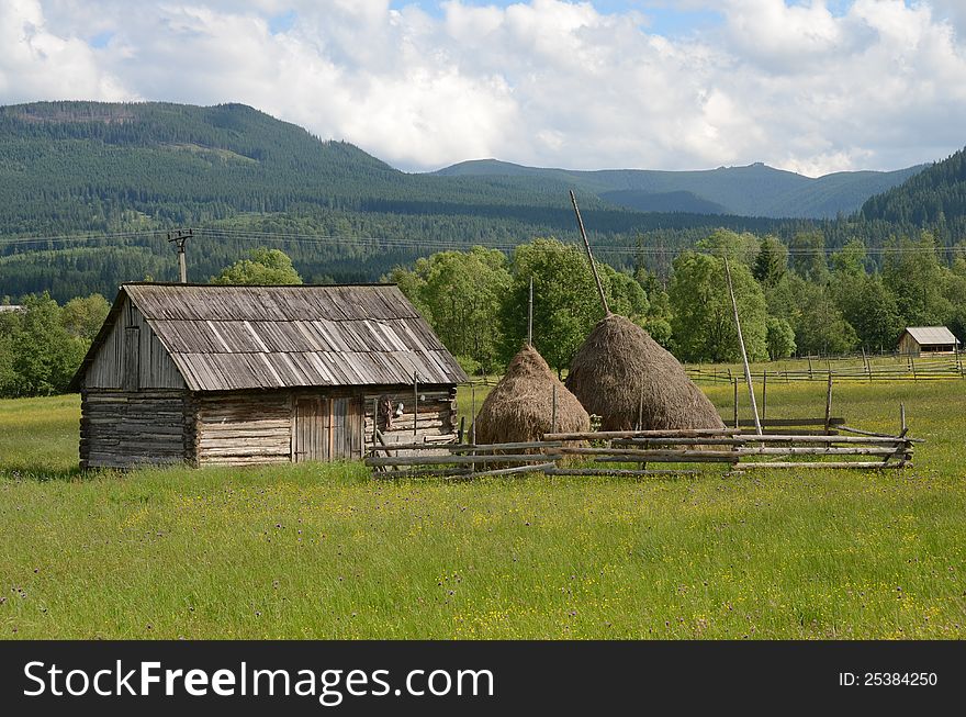 Haycock and old house in generic transylvania village. Haycock and old house in generic transylvania village