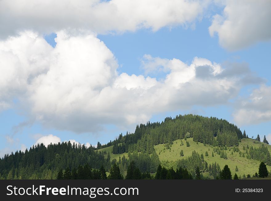 Wooden fence on the hill under cloudy sky. Wooden fence on the hill under cloudy sky