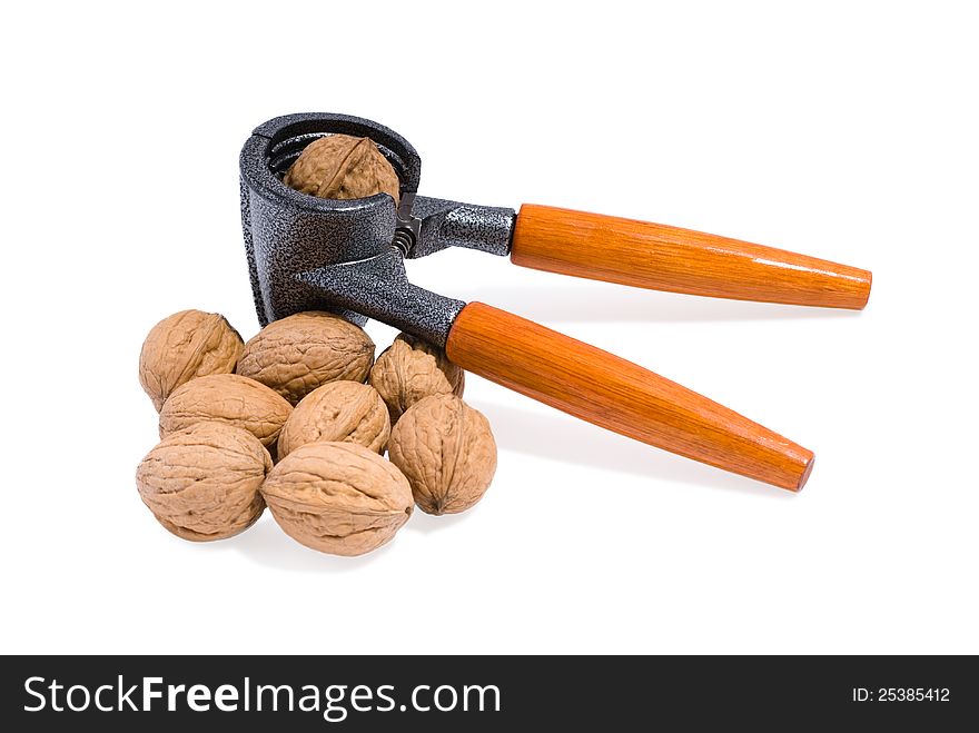 Nutcracker and walnuts on white background