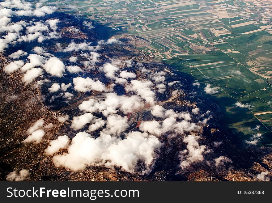 View of the mountains from an airplane above the clouds. View of the mountains from an airplane above the clouds