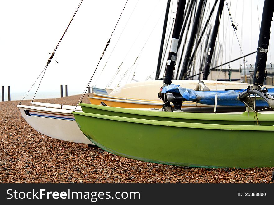 Image of sailboats on a pebbled beach