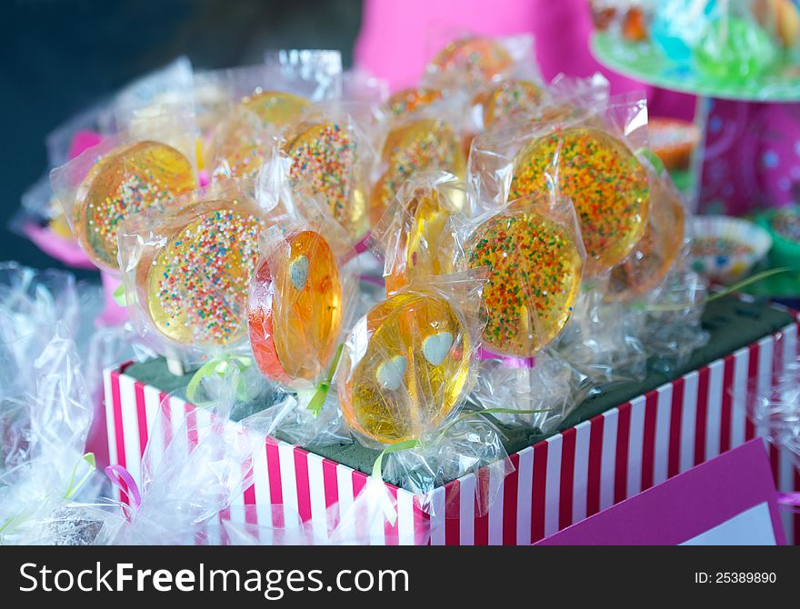 Display of delicious looking handmade lollipops in plastic wraps at kids party