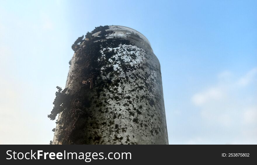 a bottle made of glass, looks very dirty.