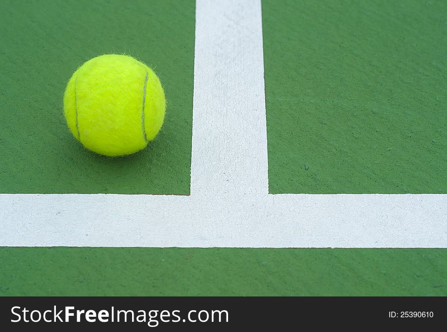 Tennis  ball on line green court