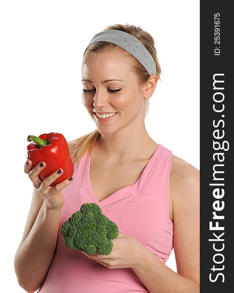 Young Woman holding a red pepper and broccoli isolated on a white background