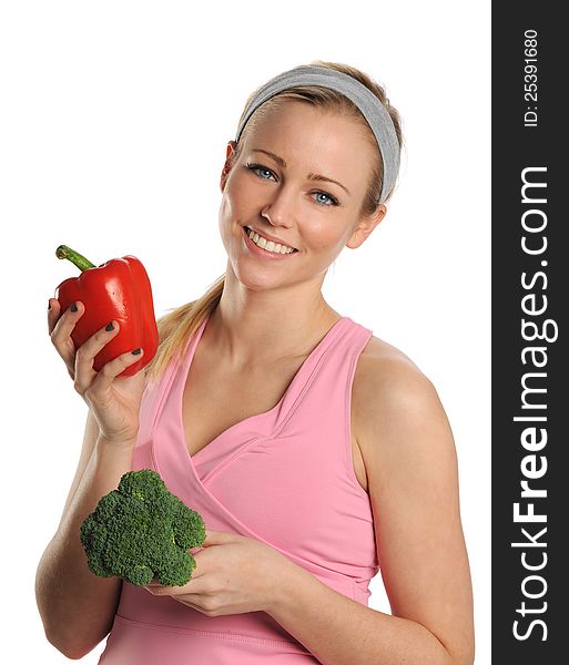 Young Woman holding a red pepper and broccoli isolated on a white background