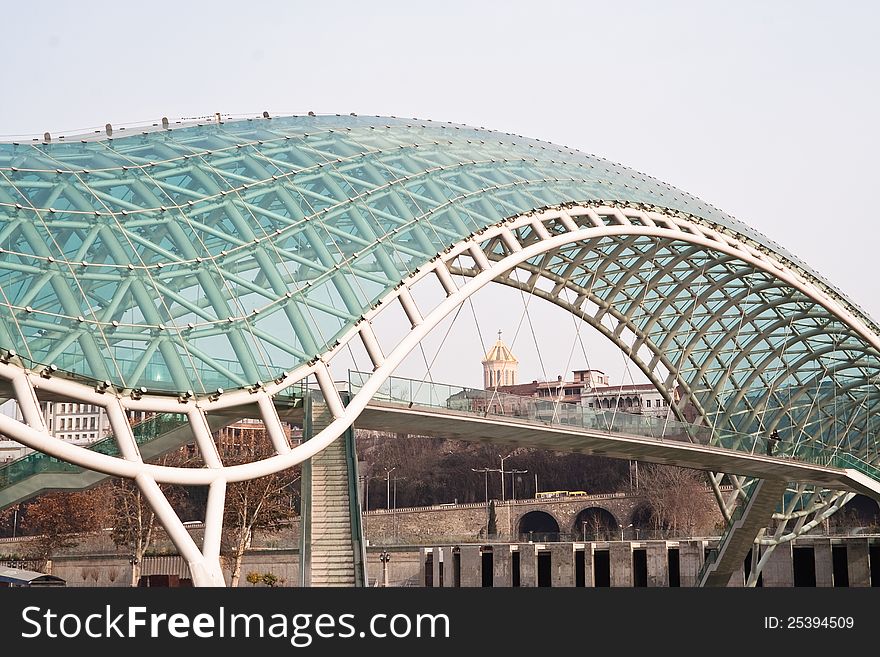 Peace Bridge - a pedestrian bridge on the Kura River in Tbilisi, Georgia. Peace Bridge - a pedestrian bridge on the Kura River in Tbilisi, Georgia