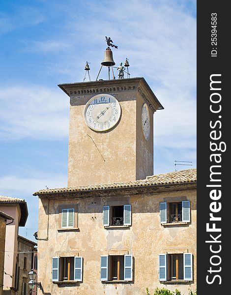 Clock tower on the main square of Orvieto in medieval style with the bells and windows shutter. Clock tower on the main square of Orvieto in medieval style with the bells and windows shutter