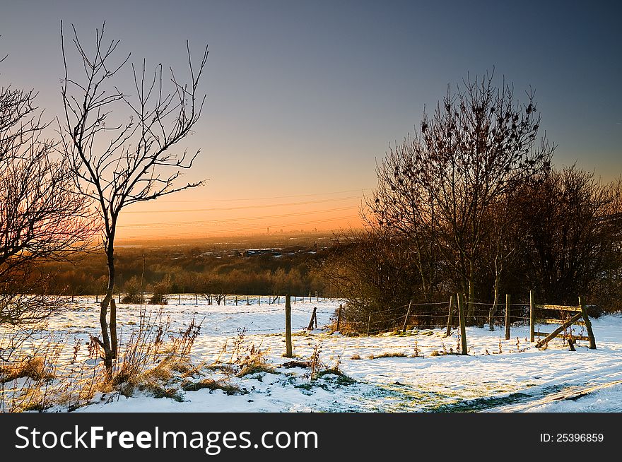 View of Manchester from high view point at Ashton Under Lyne. Landscape with sunset and snow. View of Manchester from high view point at Ashton Under Lyne. Landscape with sunset and snow.