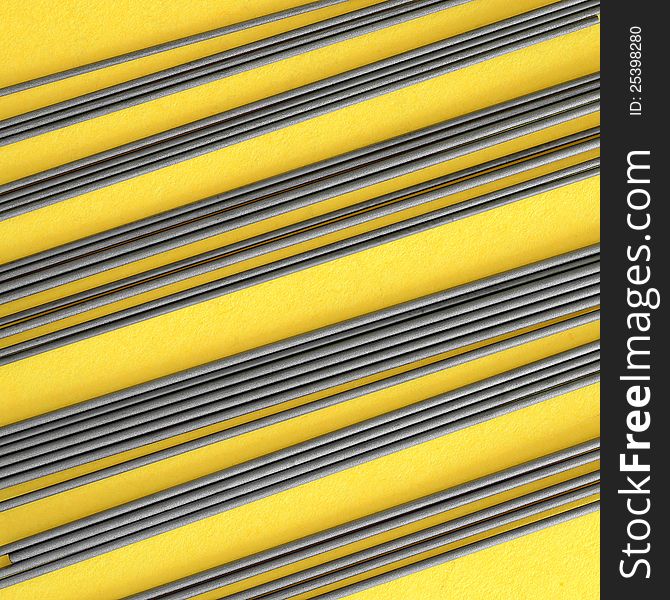 Close-up of mechanical pencil leads on yellow paper