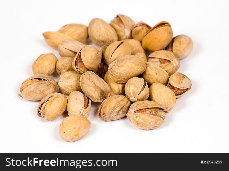 Salty pistachios on the white background. Salty pistachios on the white background