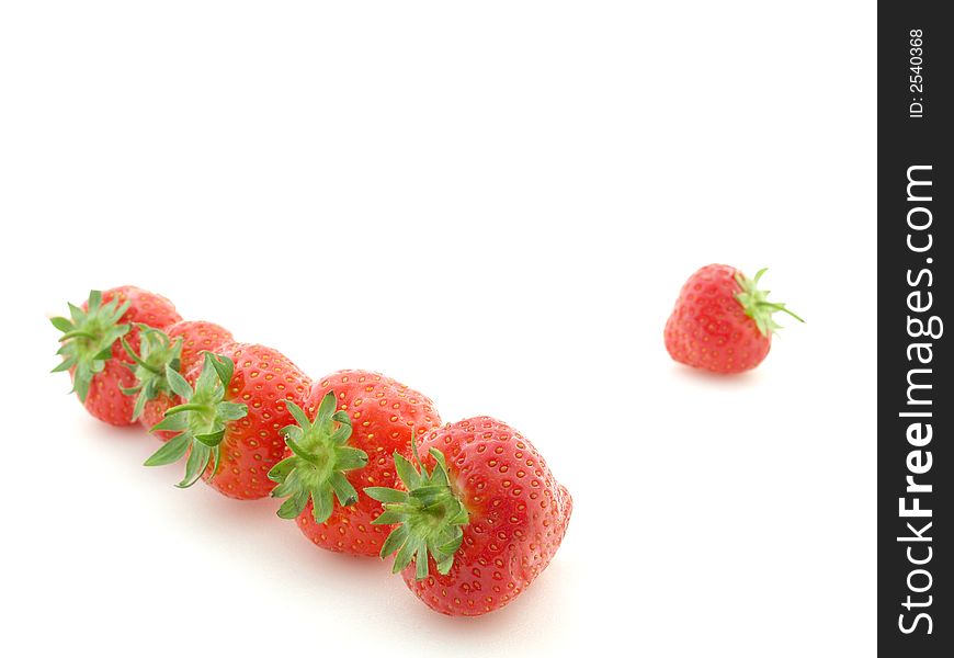 Row of strawberries on white