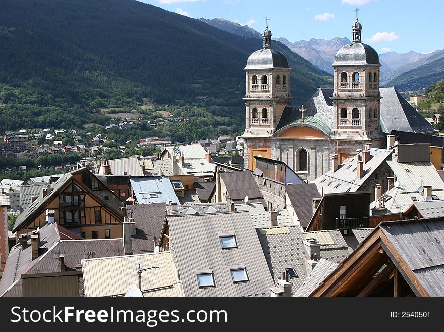 A church tower in France seen from over all roofs