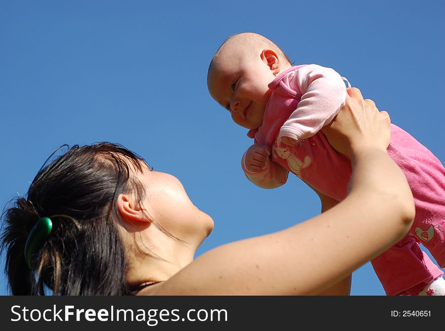 Mother and newborn girl on sky background. Mother and newborn girl on sky background