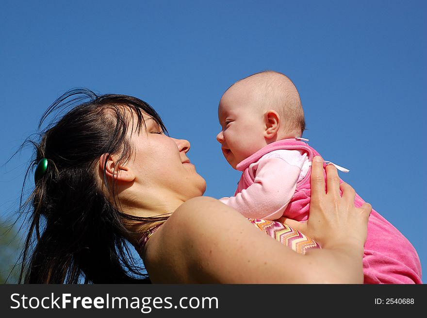 Mother and newborn girl on sky background. Mother and newborn girl on sky background