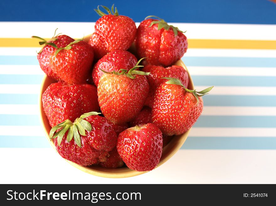 Fresh strawberries with hulls in a row, copy space, isolated on white