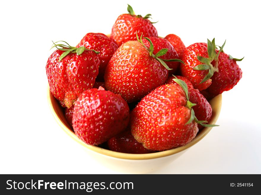 Fresh strawberries with hulls in a row, copy space, isolated on white