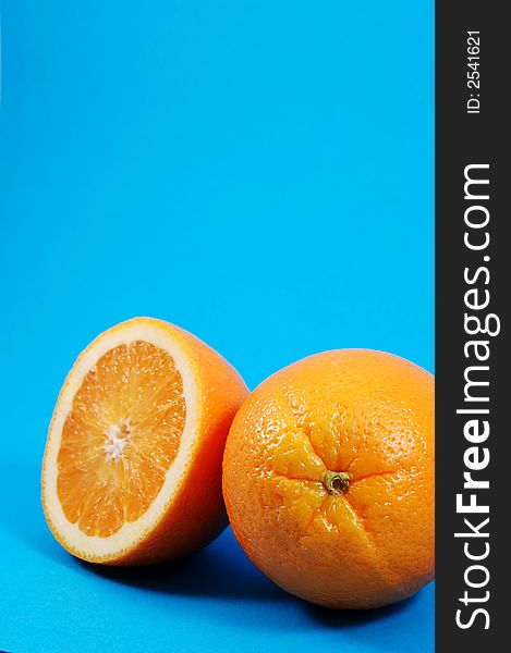 Bright juicy oranges on a blue background. Bright juicy oranges on a blue background