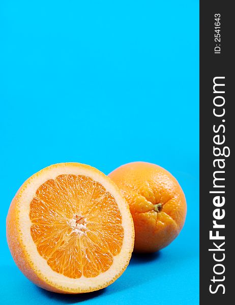 Bright juicy oranges on a blue background. Bright juicy oranges on a blue background