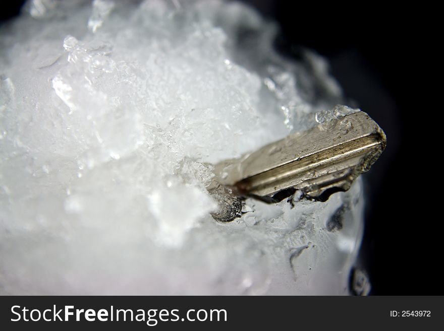 House Key frozen in a blockof ice. House Key frozen in a blockof ice