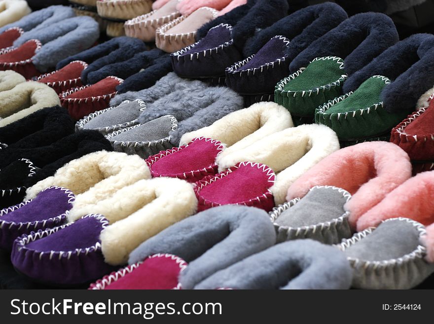 Colorful wool slippers on display.