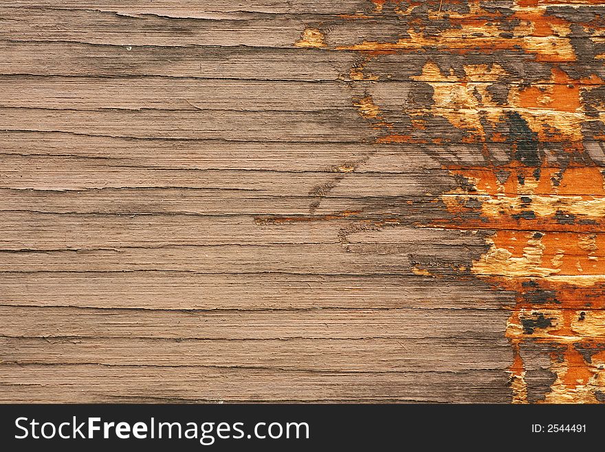 Brown grungy wooden board with vivid orange scratches on the right side. Brown grungy wooden board with vivid orange scratches on the right side