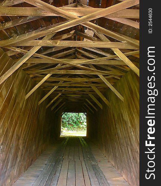 A closed antique wooden bridge over a river in the mountains of Virginia from the inside. A closed antique wooden bridge over a river in the mountains of Virginia from the inside.