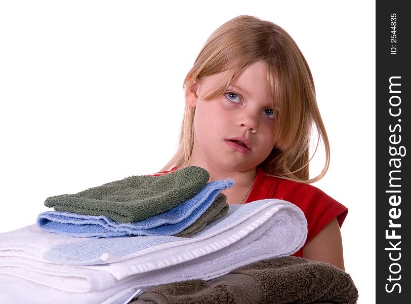 Unhappy, disgusted young girl helping with laundry carrying towels