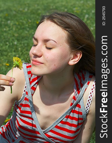 Portrait of the nice young girl with a yellow flower. Portrait of the nice young girl with a yellow flower